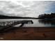 Peaceful lakefront property with sandy beach and dock at 513 Port Dr, Henderson, NC 27537