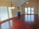 Spacious living room featuring hardwood floors, fireplace, and access to backyard at 513 Port Dr, Henderson, NC 27537
