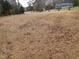 Large lot with scattered leaves and distant home at 513 Port Dr, Henderson, NC 27537