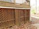 Exterior storage shed with wooden doors and lattice at 513 Port Dr, Henderson, NC 27537