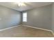 Well-lit bedroom featuring neutral walls and carpet at 58 Brightleaf Ct, Angier, NC 27501