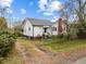 Charming white home with a red brick chimney and a small front yard at 826 Carter Ave, Durham, NC 27703