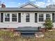 Charming home featuring a quaint front entry, complemented by classic shutters and a well-manicured lawn at 826 Carter Ave, Durham, NC 27703