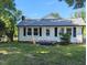 Cozy home with black shutters, a new roof, landscaped yard, and a welcoming front porch at 826 Carter Ave, Durham, NC 27703