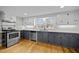 This kitchen has stylish two-tone cabinets, granite countertops, subway tile backsplash, and stainless steel appliances at 826 Carter Ave, Durham, NC 27703