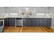 This kitchen has stylish two-tone cabinets, granite countertops, subway tile backsplash, and stainless steel appliances at 826 Carter Ave, Durham, NC 27703