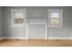 Bright living room with hardwood floors and natural light from two windows at 826 Carter Ave, Durham, NC 27703