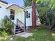 Home featuring a brick chimney and a back entrance with stairs at 826 Carter Ave, Durham, NC 27703