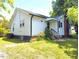 Home featuring a well-maintained lawn and a back entrance with stairs at 826 Carter Ave, Durham, NC 27703