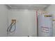 Practical utility room featuring a water heater, washer hookups, and ample space for storage at 826 Carter Ave, Durham, NC 27703
