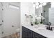 Modern bathroom with double vanity, updated fixtures, and a walk-in shower at 110-A S Hyde Park Ave, Durham, NC 27703