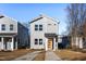 Modern two-story home with gray siding and orange door at 110-A S Hyde Park Ave, Durham, NC 27703