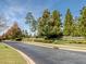 Street view featuring a landscaped median and the Chapel Ridge community entrance sign at 12 Cabin Crk, Pittsboro, NC 27312