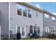 Townhome back view featuring small patio with seating and small lawn at 236 George Pine Way, Knightdale, NC 27545