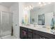 Elegant bathroom with double sinks, a walk-in shower, and a large mirror at 236 George Pine Way, Knightdale, NC 27545