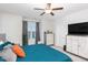 Cozy bedroom with a blue bed, wooden furniture, and large window at 236 George Pine Way, Knightdale, NC 27545