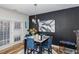 Stylish dining area with a dark accent wall, modern art, and seating for four near lots of natural light at 236 George Pine Way, Knightdale, NC 27545