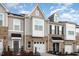 Modern townhome with brick and siding exterior and two-car garages at 236 George Pine Way, Knightdale, NC 27545