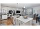Modern kitchen island with granite countertops and stainless steel sink in an open concept living space at 236 George Pine Way, Knightdale, NC 27545