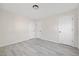 Bright bedroom featuring wood-look floors, neutral walls and three doors at 409 Avery Street St, Garner, NC 27529