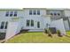 Backyard features a white fence, well-kept grass, and a small patio area perfect for relaxing at 43 Honeydew Way, Clayton, NC 27520