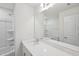 Bright bathroom with a large mirror above a white quartz countertop and sink at 43 Honeydew Way, Clayton, NC 27520
