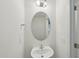 Charming powder room with a pedestal sink, oval mirror, and neutral decor at 43 Honeydew Way, Clayton, NC 27520