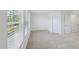 Bright bedroom with neutral carpet, two doors, and a large window for ample natural light at 43 Honeydew Way, Clayton, NC 27520