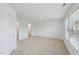 Spacious bedroom featuring plush neutral carpet, large windows, and an attached bathroom at 43 Honeydew Way, Clayton, NC 27520