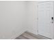 Clean, bright entryway with light wood floors and a white door at 43 Honeydew Way, Clayton, NC 27520