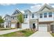 Attractive townhouse exteriors with diverse siding, lawns, driveways, and blue sky background at 43 Honeydew Way, Clayton, NC 27520