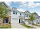 Attractive townhouse exteriors with diverse siding, lawns, driveways, and blue sky background at 43 Honeydew Way, Clayton, NC 27520