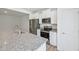 Open kitchen features stainless steel appliances, white cabinets, and a granite-topped island at 43 Honeydew Way, Clayton, NC 27520