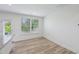 Bright breakfast nook features wood floors, white walls, and natural light from windows and a glass door at 43 Honeydew Way, Clayton, NC 27520
