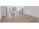 Open-concept living space with wood floors, island kitchen, and staircase at 43 Honeydew Way, Clayton, NC 27520