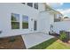Back patio with white siding, an access door, large windows, and a well-maintained lawn at 43 Honeydew Way, Clayton, NC 27520