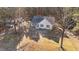 Aerial view of a charming home with a long driveway and wooded lot at 5705 Katha Dr, Holly Springs, NC 27540