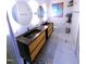 Bathroom with dual sink vanity, round mirrors, and decorative accents at 5705 Katha Dr, Holly Springs, NC 27540