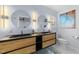 Modern bathroom with double vanity, wood drawers, and round mirrors for contemporary design at 5705 Katha Dr, Holly Springs, NC 27540