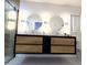 Modern bathroom with double sink vanity, and lighted mirrors at 5705 Katha Dr, Holly Springs, NC 27540
