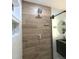 Modern shower space featuring an overhead shower head, wooden tile, and custom shelving niche at 5705 Katha Dr, Holly Springs, NC 27540