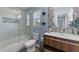 Bathroom featuring a glass enclosed shower, modern toilet, wood vanity, and round mirror at 5705 Katha Dr, Holly Springs, NC 27540