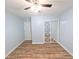 Bedroom featuring wood-look flooring, light blue walls and closet with decorative barn-style door at 5705 Katha Dr, Holly Springs, NC 27540