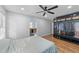 Bright bedroom with wood floors, ceiling fan, and closet with an en-suite bathroom at 5705 Katha Dr, Holly Springs, NC 27540
