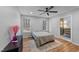 Well-lit bedroom with wood floors, a ceiling fan, and an en-suite bathroom at 5705 Katha Dr, Holly Springs, NC 27540