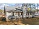 Rear exterior view highlighting the foundation, windows, and back door at 5705 Katha Dr, Holly Springs, NC 27540