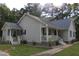 Single-Gathering home featuring a charming front porch and sidewalk leading to the entrance at 5705 Katha Dr, Holly Springs, NC 27540