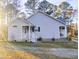 Side view of home showcasing the porch and sidewalk leading to the entrance at 5705 Katha Dr, Holly Springs, NC 27540