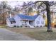 Charming single Gathering home with blue shutters, front porch, and well maintained landscaping at 5705 Katha Dr, Holly Springs, NC 27540