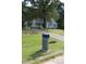 Charming home nestled among lush green trees and a well-manicured front yard at 5705 Katha Dr, Holly Springs, NC 27540